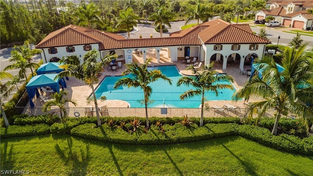 view of swimming pool featuring a patio area and a yard