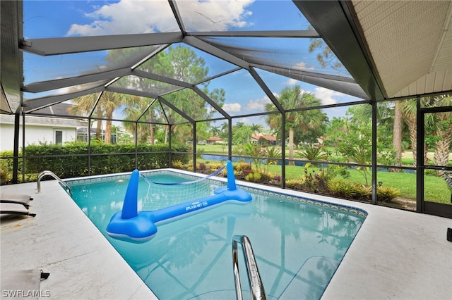 view of swimming pool featuring a patio area and a lanai