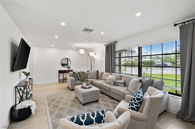 living room featuring a healthy amount of sunlight and light hardwood / wood-style flooring