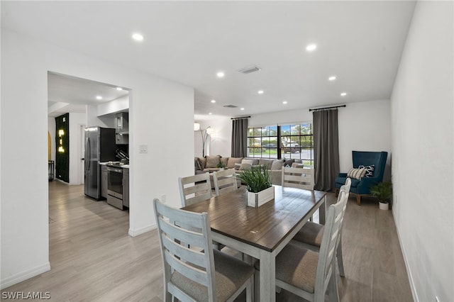 dining space with light hardwood / wood-style floors