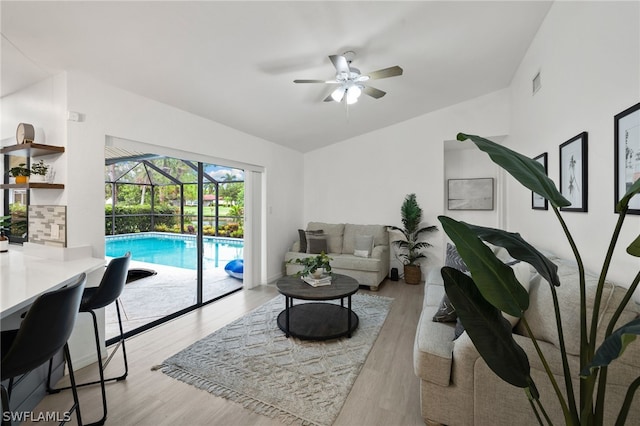 living room with light wood-type flooring and ceiling fan