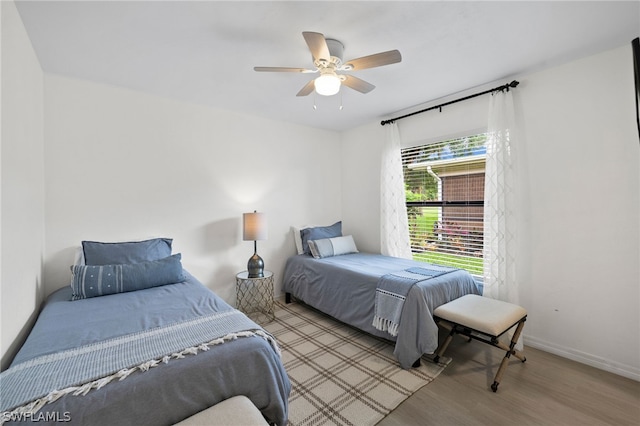 bedroom with light wood-type flooring and ceiling fan