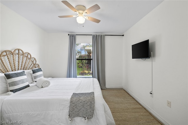 bedroom featuring light carpet and ceiling fan