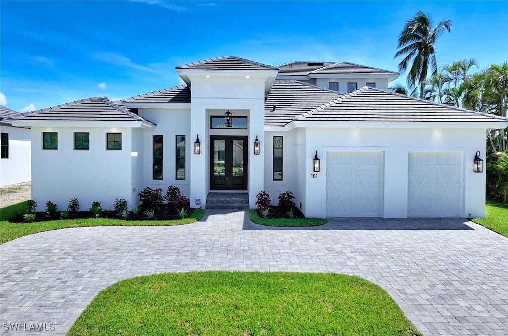 view of front of property featuring a garage and french doors