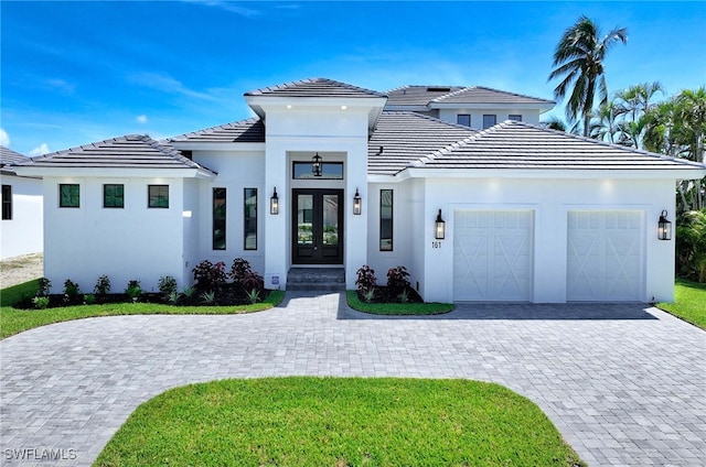 view of front of property featuring a garage and french doors