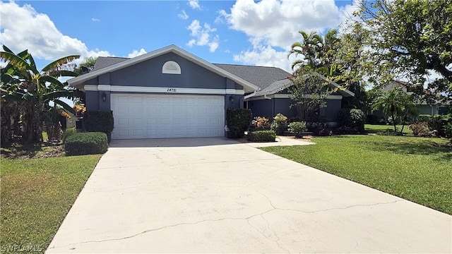 ranch-style house featuring a garage and a front lawn