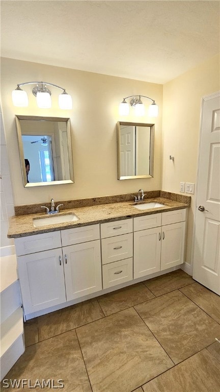 bathroom with tile patterned floors and dual bowl vanity