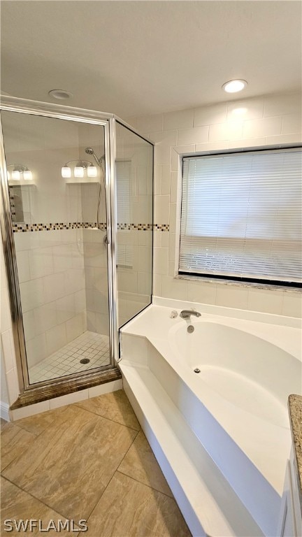 bathroom with vanity, independent shower and bath, and tile patterned floors