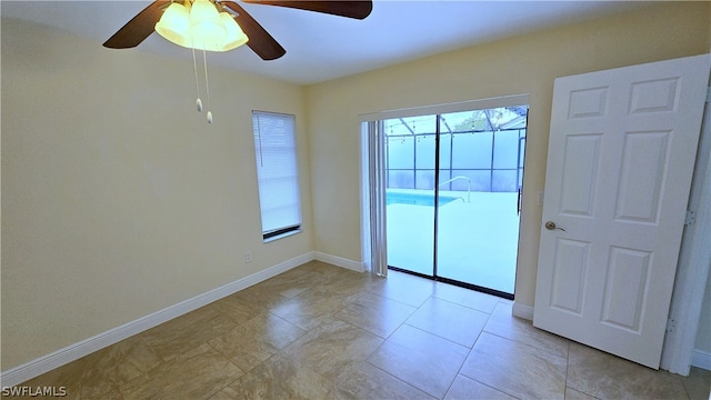 unfurnished bedroom featuring multiple windows, a closet, light tile patterned floors, and ceiling fan