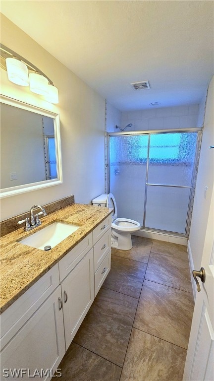 bathroom with tile patterned floors, vanity, and toilet