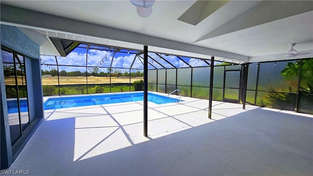 view of swimming pool with a patio area, a lanai, and ceiling fan