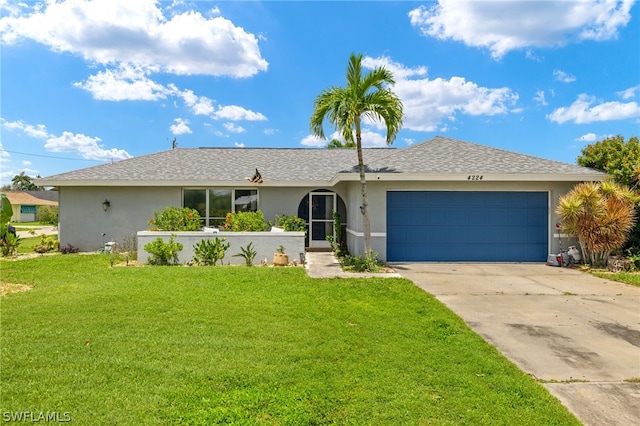 ranch-style home featuring a garage and a front lawn