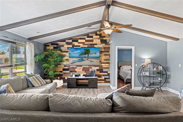 living room with vaulted ceiling with beams, light wood-type flooring, and ceiling fan