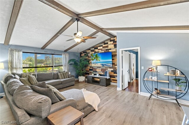 living room featuring lofted ceiling with beams, light wood-type flooring, and ceiling fan