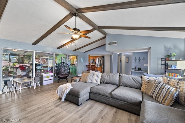 living room with beam ceiling, wood-type flooring, high vaulted ceiling, and ceiling fan