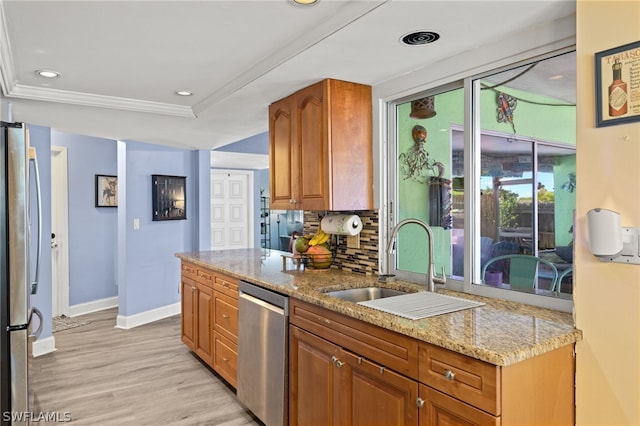 kitchen featuring light wood-type flooring, sink, light stone counters, appliances with stainless steel finishes, and backsplash