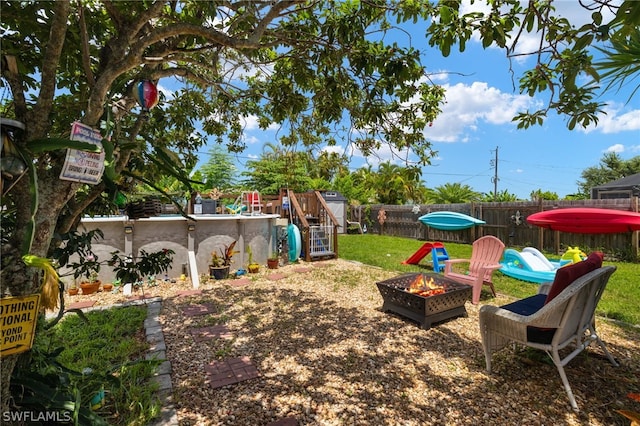 view of yard with a fire pit and a playground