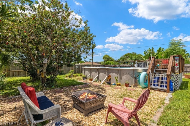 view of yard featuring an outdoor fire pit