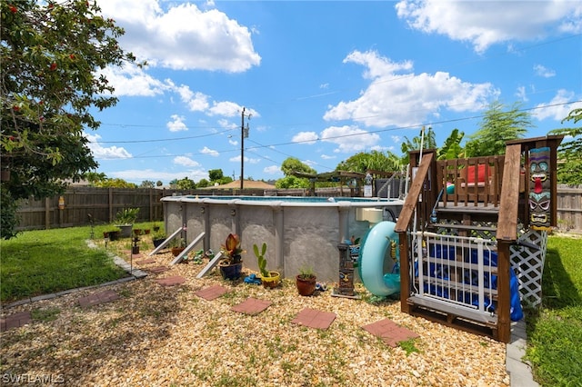 view of yard with a swimming pool side deck