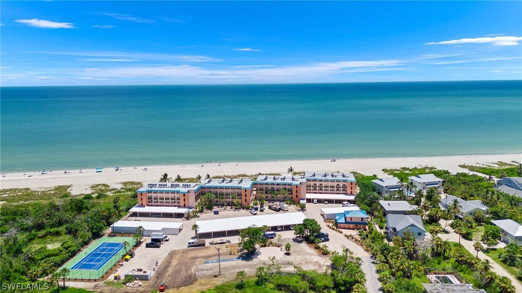 bird's eye view with a water view and a beach view