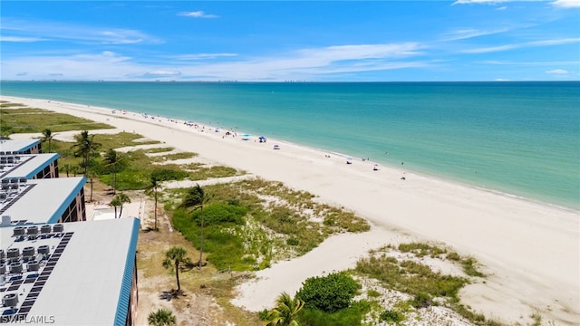 bird's eye view with a water view and a view of the beach