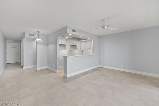 unfurnished living room featuring ceiling fan and light tile patterned floors