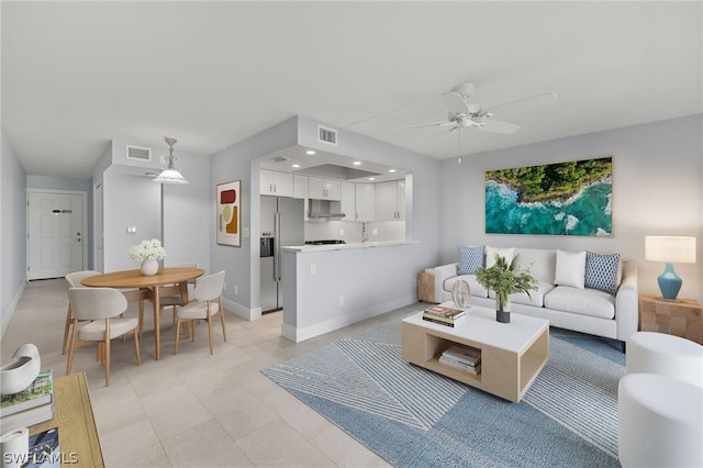 tiled living room featuring ceiling fan