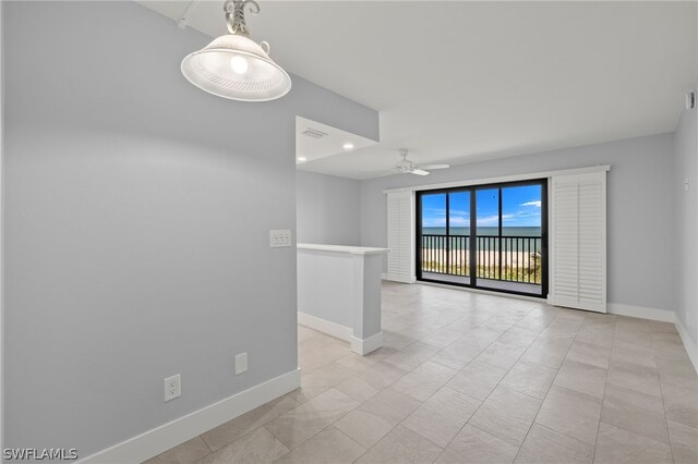 empty room with light tile patterned flooring and ceiling fan