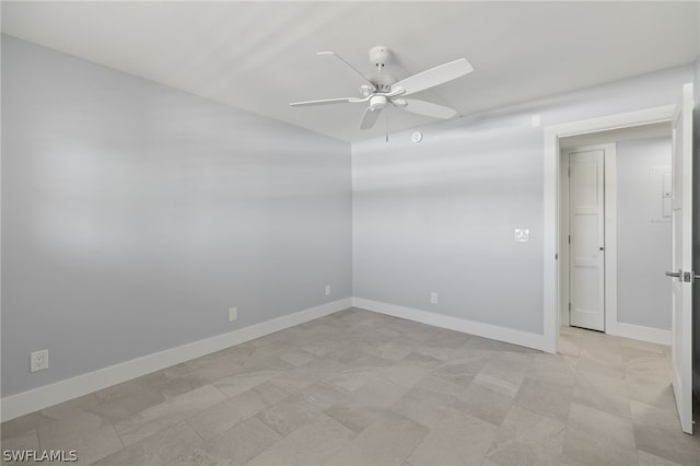 tiled empty room featuring ceiling fan