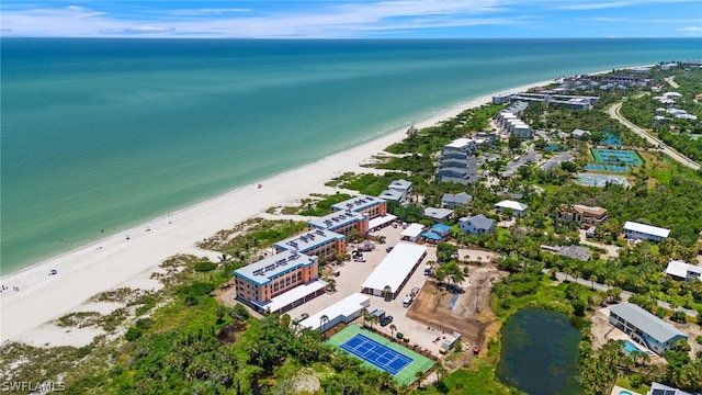 drone / aerial view featuring a water view and a beach view