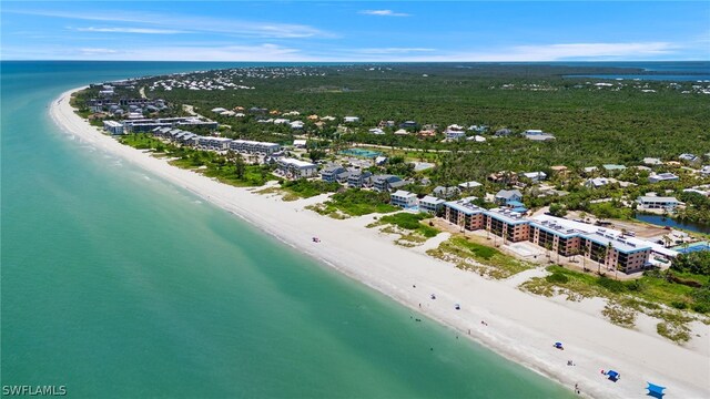 drone / aerial view featuring a view of the beach and a water view