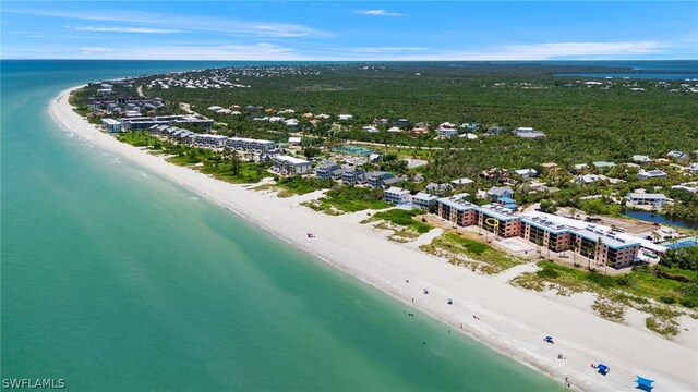 bird's eye view with a water view and a beach view