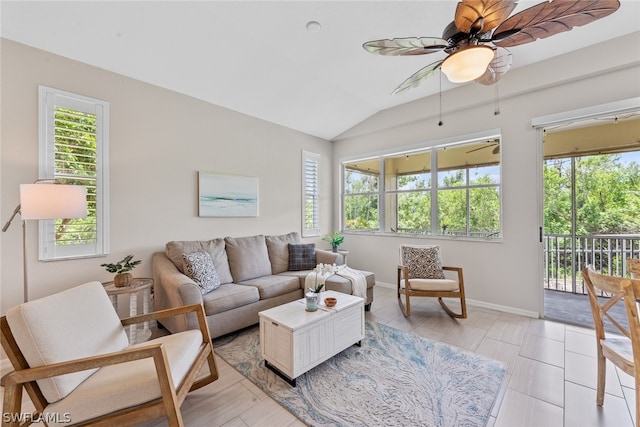 living room featuring vaulted ceiling, ceiling fan, and a healthy amount of sunlight