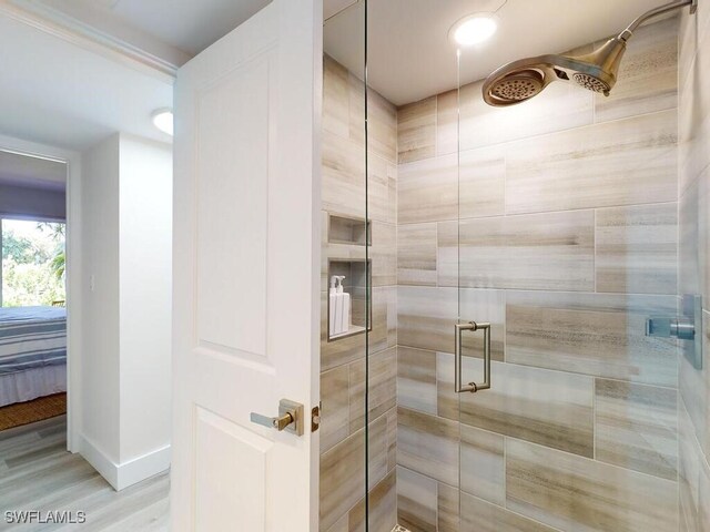 bathroom featuring walk in shower and hardwood / wood-style floors