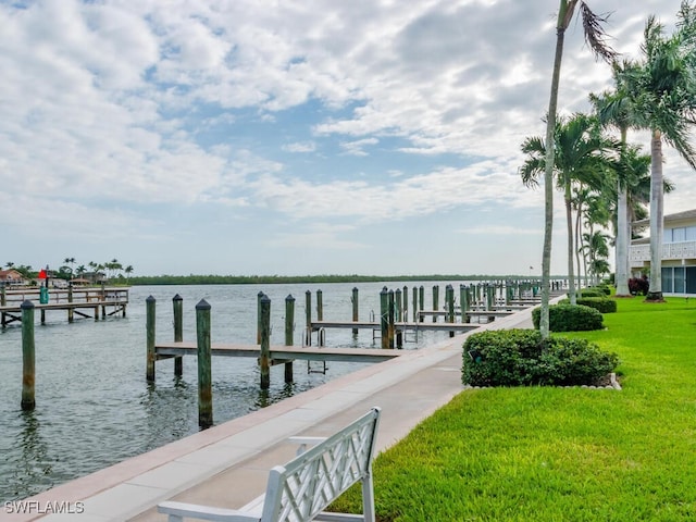 dock area featuring a water view and a yard