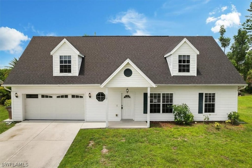 new england style home with a front lawn and a garage