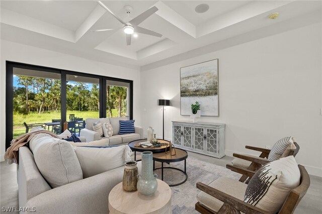 living room with coffered ceiling and ceiling fan