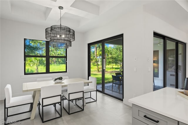 tiled dining room featuring coffered ceiling and a chandelier