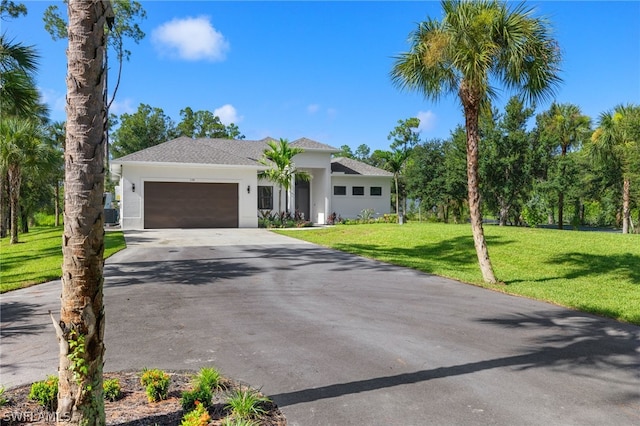 view of front of home with a garage and a front yard