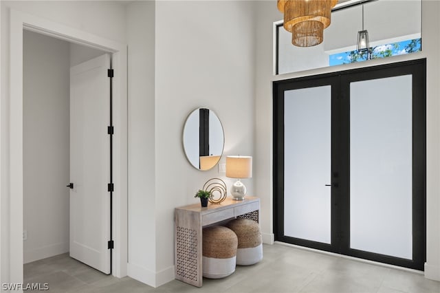 entrance foyer with baseboards and french doors