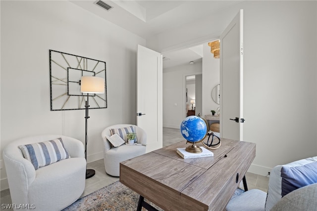 living area featuring light tile patterned floors, visible vents, and baseboards