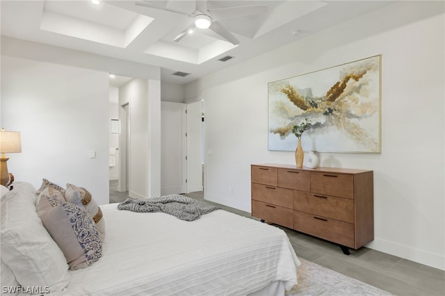 bedroom with coffered ceiling, light tile patterned floors, and ceiling fan