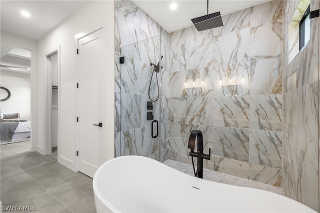 bathroom featuring tile patterned flooring and shower with separate bathtub