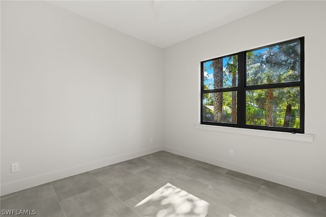 unfurnished room with light tile patterned flooring