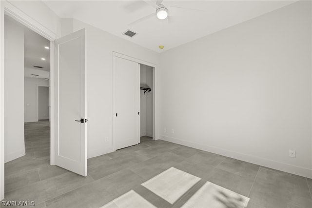 unfurnished bedroom featuring light tile patterned flooring, a closet, and ceiling fan