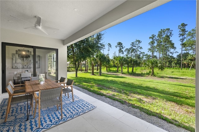 view of patio featuring outdoor dining area and a ceiling fan