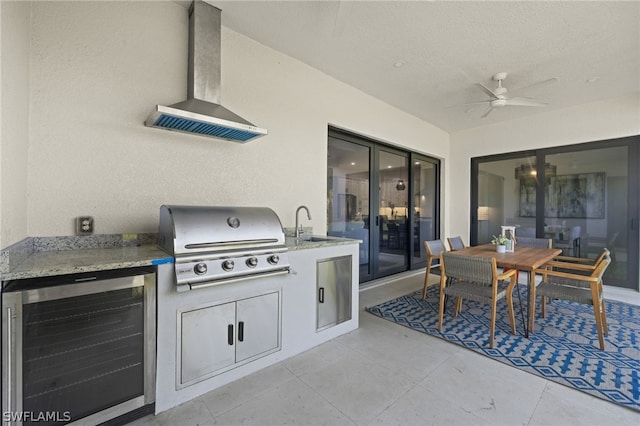 view of patio / terrace with sink, grilling area, ceiling fan, and an outdoor kitchen