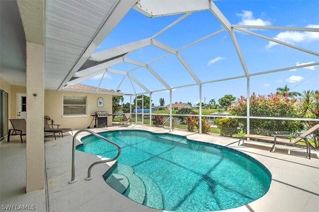 view of pool featuring a patio and glass enclosure