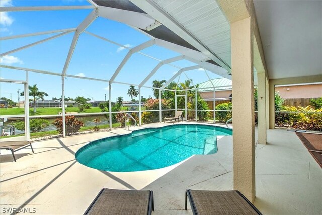 view of pool featuring a patio area and glass enclosure