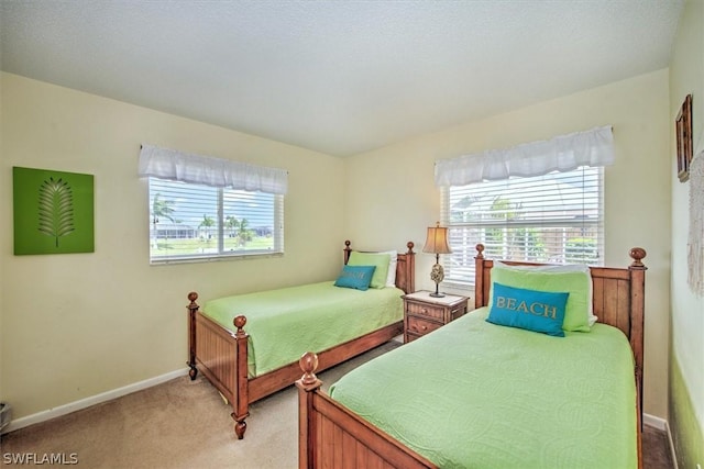 carpeted bedroom with multiple windows